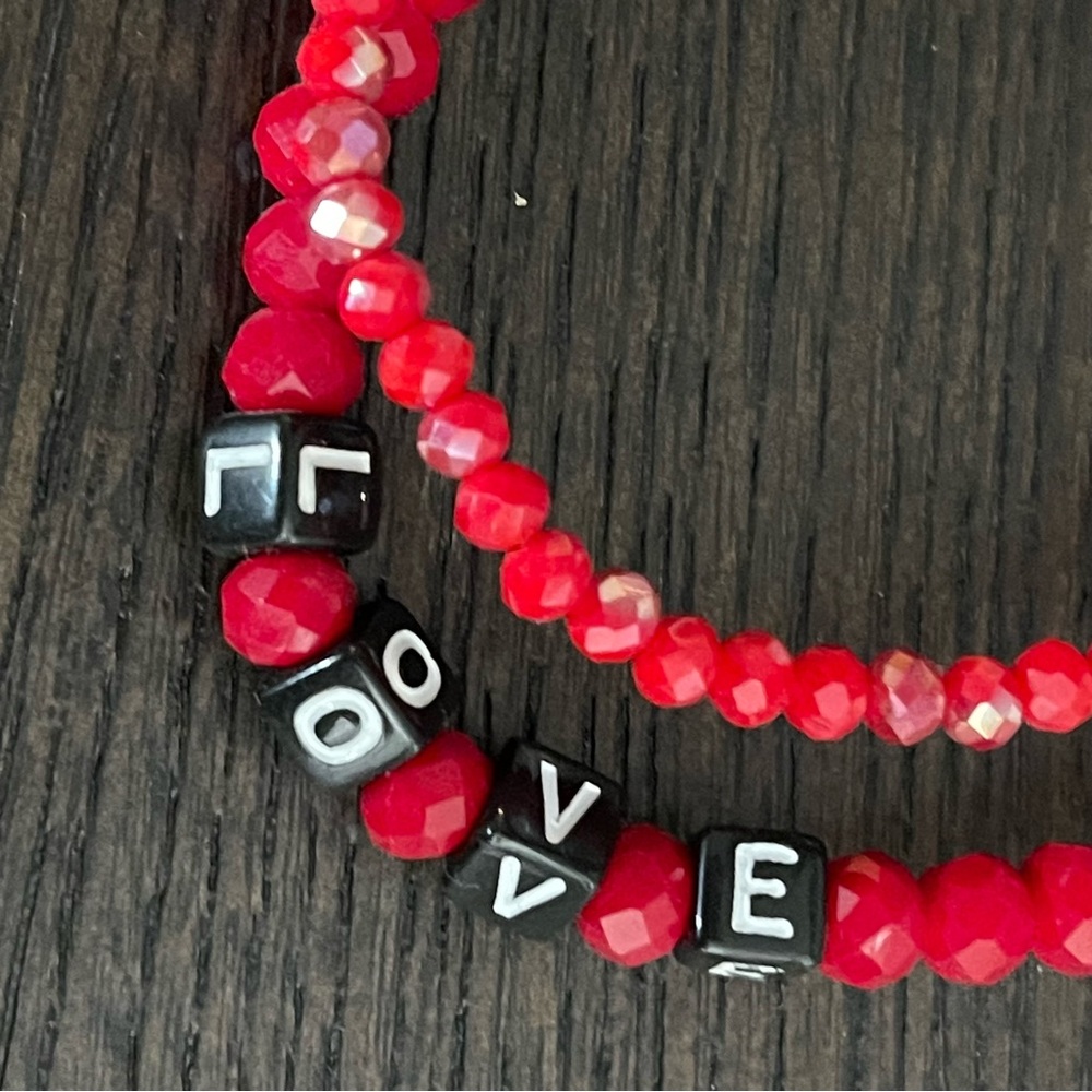 TWO RED BEADED CRYSTAL STRETCH LOVE BRACELETS WITH BLACK AND WHITE LETTERING. - Picture 2 of 5